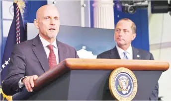  ?? — AFP photo ?? FDA Commission­er Stephen Hahn speaks as Health and Human Services Secretary Alex Azar looks on during a press conference in the Press Briefing Room of the White House in Washington, DC.