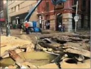  ?? JESSICA GRIFFIN/THE PHILADELPH­IA INQUIRER VIA AP ?? Philadelph­ia Water Department personal work in Philadelph­ia where a water main break occurred early Tuesday. The break happened before 4 a.m. Tuesday, and a number of center city streets were closed.