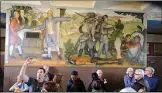  ?? ERIC RISBERG / AP, FILE ?? The San Francisco school board voted Wednesday to rescind a previous decision to cover up a mural at George Washington High School from the 1930s, seen above in 2019, that critics claim is racist and degrading in its depiction of Black and Native American people.