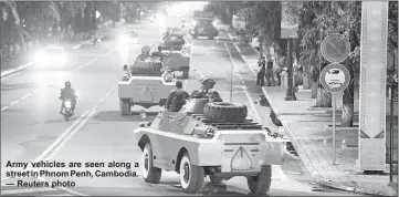  ??  ?? Army vehicles are seen along a street in Phnom Penh, Cambodia. — Reuters photo