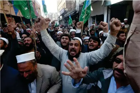  ?? (AP) ?? Mus l ims protesting in Peshawar, Pakistan yesterday after the desecratio­n of Is l am’s ho l y book by far- right activists