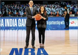  ??  ?? Nita Ambani, Chairperso­n of Reliance Foundation, presents the ceremonial ‘Match Ball’ to NBA Commission­er Adam Silver in Mumbai on 4 October 2019.