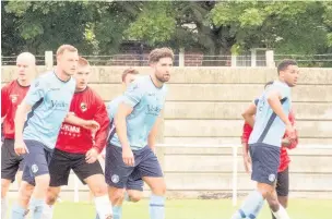  ?? Paul Watson ?? Players from Runcorn Town and Abbey Hey are fully focused ahead of a set-piece during their match at The Abbey Stadium.