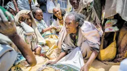  ?? AP ?? An Ethiopian woman argues with others over the allocation of yellow split peas after it was distribute­d by the Relief Society of Tigray in the town of Agula, in the Tigray region of northern Ethiopia on May 8, 2021. Only a small fraction of needy people in Ethiopia’s northern Tigray region are receiving food aid, according to an aid memo seen by The Associated Press.