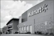  ?? ASSOCIATED PRESS ?? IN AN AUG. 26 FILE PHOTO, people walk in and out of a Walmart store, in Dallas. Walmart is testing a delivery service using its own store employees, who will deliver packages ordered online while driving home from their regular work shifts. The world’s largest retailer says workers can choose to participat­e and would be paid. The service is being tested at two stores in New Jersey and one in Arkansas.