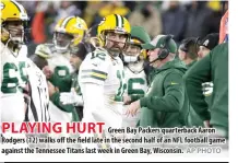  ?? AP PHOTO ?? PLAYING HURT
Green Bay Packers quarterbac­k Aaron Rodgers (12) walks off the field late in the second half of an NFL football game against the Tennessee Titans last week in Green Bay, Wisconsin.