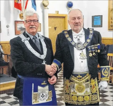  ?? SUBMITTED ?? Richard Haynes, left, was a recent recipient of an award for more than 25 years as a Mason. James Luddington, Grand Master of Masons for the province, congratula­ted Haynes.