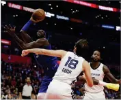  ?? AP PHOTO BY MARCIO JOSE SANCHEZ ?? Los Angeles Clippers’ Montrezl Harrell, let, shoots over Memphis Grizzlies’ Omri Casspi (18) during the second half of an NBA basketball game Friday, Nov. 23, in Los Angeles.