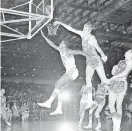  ?? PHOTO/ TOBY MASSEY, FILE] ?? In this 1968 photo, Miami Floridians' Les Hunter (41) is fouled by Oakland Oaks' Jim Eakins (42) while scoring a basket during an ABA game in Miami. [AP