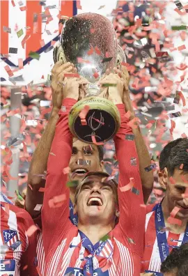  ?? Picture: AFP ?? GLORY NIGHT. Atletico Madrid’s Antoine Griezmann holds the Uefa Super Cup aloft after they beat Europen champions Real Madrid at Lillekula Stadium in Tallinn on Wednesday night.