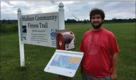  ?? BILL DEBUS — THE NEWS-HERALD ?? Charley Barnicoat Jr. stands beside one of the 20 posts and display panels comprising a StoryWalk that he constructe­d on the Madison Community Fitness Trail in Madison Township. He built the StoryWalk as a project required to earn the rank of Eagle Scout in the Boy Scouts of America. A StoryWalk is a series of signs, often placed along a walking or fitness path, that display laminated pages from a children’s book, so a person can read the entire story from start to finish. Charley, of Madison Township, is a senior at Madison High School and Auburn Career Center in Concord Township.