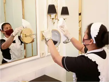  ??  ?? a housekeepi­ng staff cleaning a room in a luxury hotel in Vienna, austria. Guests need to see and be assured that hotels take all measures of safety and hygiene seriously. — reuters