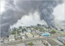  ?? Picture: JONE TUIIPELEHA­KI/VIA REUTERS ?? Smoke rises above buildings after days of unrest in Honiara, Solomon Islands on November 25, 2021 in this
still image obtained from a video.