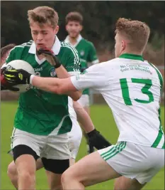  ??  ?? Robert Kinsella of Cloughbawn tries to burst past Sam Kelly (Crossabeg-Ballymurn) during Saturday’s drawn IAFC semi-final.