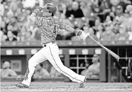  ?? DAVID KOHL, USA TODAY SPORTS ?? Scooter Gennett hits a grand slam against the Cardinals in the third inning June 6, the first of his four home runs that night. He is the 17th major league to accomplish the four-homer feat.