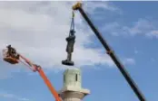  ??  ?? ROBERT E. LEE STATUE is removed from its pedestal in New Orleans last May. It was one of four monuments to Confederat­e leaders removed by the city. A nationwide controvers­y has erupted over statues honoring people considered to be racists.