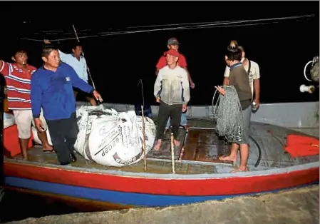  ?? — Pic courtesy of China Press ?? Safe and sound: The fishermen from Sungai udang were rescued near Pulau Kendi around six hours after their boat capsized.