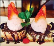  ??  ?? Executive Chef Rob Nelson recently unveiled a new dessert on Valentine’s Day: Strawberry coulis filled buttermilk biscuits topped with chocolate sauce, strawberry ice cream, mint and fresh berries. Tusk and Trotter is always experiment­ing with new food...