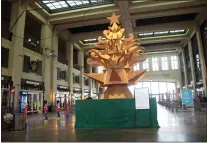  ?? WAYNE PARRY — THE ASSOCIATED PRESS ?? “The Giving Tree,” a Christmas tree display made out of cardboard at Asbury Park NJ’s Convention Hall that is delighting many in the seaside town, but dismaying others who miss the fresh-cut natural tree that is usually on display there during the holidays.