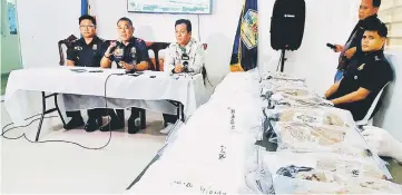  ??  ?? File photo shows police officials (in blue) and PDEA local director Christian Frivaldo (second right) sitting next to packs of cocaine during a press conference in Legazpi City. — AFP photo