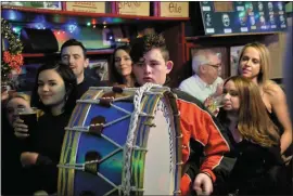  ??  ?? Eoin Moriarty playing with the Dingle Fife & Drum in O’Flaherty’s bar before heading out on his first New Year’s Eve parade as big drummer with the band.