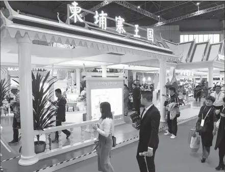  ?? CHEN FEI / XINHUA ?? Visitors walk past the Cambodian pavilion during the second China Internatio­nal Import Expo in Shanghai on Nov 6, 2019.
