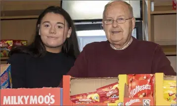  ??  ?? Sean Kinsella, who was spending his final few days serving in the Dun Mhuire Theatre shop after volunteeri­ng there for 60 years, with assistant Sarah Doyle.