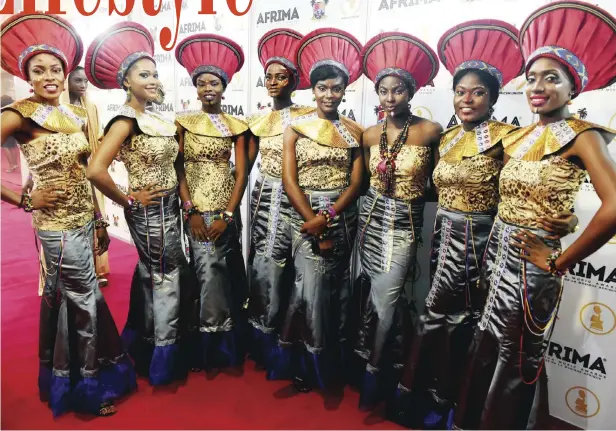  ?? — AFP ?? Hostesses pose for photograph during the All Africa Music Awards (AFRIMA) ceremony in Lagos Sunday. 82-year-old Cameroonia­n vibraphone and saxophonis­t Manu Dibango, was recognized for making tremendous contributi­ons to African music, especially for...