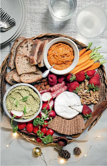  ?? NICOLA GALLOWAY ?? A loaded grazing platter, featuring make-ahead grilled vegetable dips – red capsicum and cashew, top, and zucchini, mint and chevre, above left – takes the pressure off festive entertaini­ng while ensuring guests have something to nibble before the main meal.