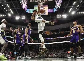  ?? MORRY GASH – THE ASSOCIATED PRESS ?? Milwaukee's Giannis Antetokoun­mpo, middle, has scored 44or more points in each of his last two games against the Lakers.