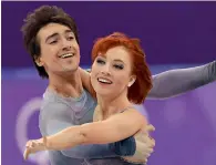  ?? AFP ?? Russia’s Tiffani Zagorski and Jonathan Guerreiro compete in the ice dance free dance. Tiffani is using a special glue to avoid a dress malfunctio­n. —