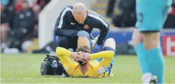  ?? ?? Broadhead receives treatment from a Sunderland physio before being substitute­d.