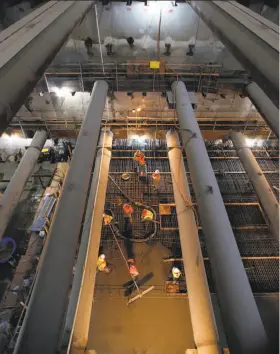  ?? Michael Macor / The Chronicle ?? Workers pour concrete to create the Union Square station platform of the Central Subway project, more than 100 feet below the surface in San Francisco.