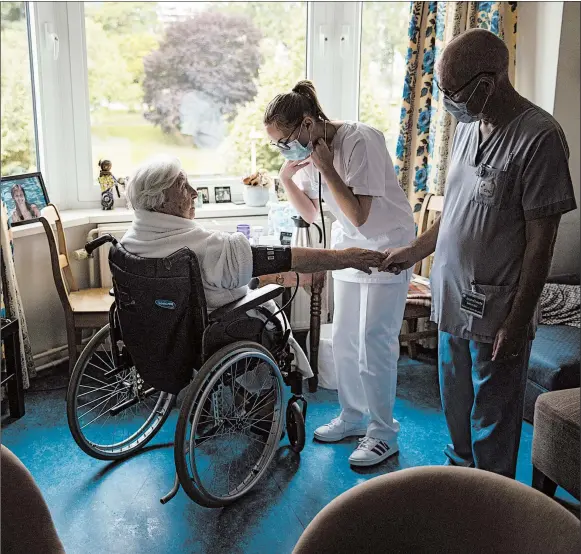  ?? FRANCISCO SECO/AP ?? Nurse Jean-Claude Feda, right, and trainee Lyson Rousseau take the blood pressure of Odette Defraigne-Schmit in July at a nursing home in Belgium.