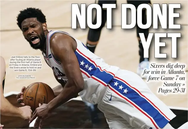  ?? JOHN BAZEMORE — THE ASSOCIATED PRESS ?? Joel Embiid falls to the floor after fouling an Atlanta player during the first half of Game 6 on Friday in Atlanta. Embiid and the Sixers arose to hold on and
win Game 6, 104-99.