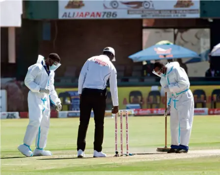  ?? AP ?? Need of the hour: Cricket ocials inspect the pitch during the second Test match between Zimbabwe and Pakistan at the Harare Sports Club. Among the top teams during the Flower brothers’ era, the nation barely competes against the best now and hopes to play more Test cricket.