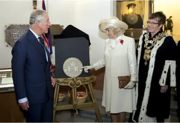  ??  ?? Above: Their Royal Highnesses unveiled a plaque bearing the cypher for the Commonweal­th Walkway during their official visit to the Pukeahu National War Memorial Park. Mayor WadeBrown is to the right.