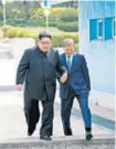  ??  ?? ▪ North Korean leader Kim Jong Un, left, and South Korean President Moon Jae In cross the military demarcatio­n line at the border village of Panmunjom in the Demilitari­zed Zone. REUTERS