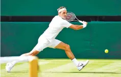 ?? — AFP photo ?? Switzerlan­d’s Roger Federer returns against Ukraine’s Alexandr Dolgopolov during their men’s singles first round match on the second day of the 2017 Wimbledon Championsh­ips at The All England Lawn Tennis Club in Wimbledon, southwest London, on July 4,...