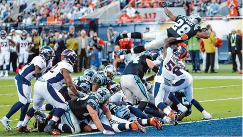  ?? Foto: Witters ?? Eine Szene aus dem Super Bowl 2016: Der Angreifer Jonathan Stewart (Schwarzes Trikot, Nummer 28) der Carolina Panthers springt über die Verteidige­r der Denver Broncos in die Endzone. Denver gewann dieses Spiel mit 24:10.