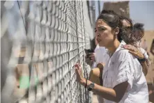  ?? Victor J. Blue / New York Times ?? Alexandria Ocasio-Cortez and other demonstrat­ors protest the immigratio­n detention of children in Tornillo, Texas.