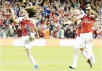  ??  ?? Arsenal’s French midfielder Matteo Guendouzi (left), celebrates with German defender Shkodran Mustafi (second right) and English midfielder Reiss Nelson after they won 6-5 on penalties during the Internatio­nal Champions Cup football match between...