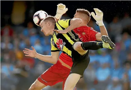  ?? GETTY IMAGES ?? Phoenix goalkeeper Filip Kurto collides with team-mate Ryan Lowry last night in Sydney.