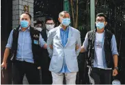  ?? Vernon Yuen / AFP via Getty Images ?? Police lead Jimmy Lai from his Hong Kong home after he was arrested under a new security law.