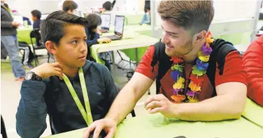  ?? GARY REYES/STAFF ?? Johan Huizar, 10, gets help from instructor Dan Brockwell during an intro to JavaScript programmin­g course at a STEM program conducted by iD Tech Camps at Don Callejon Elementary School in Santa Clara.