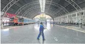  ?? CHANAT KATANYU ?? A worker cleans the floor at Hua Lamphong railway station. The Finance Ministry has been tasked with finding measures to help welfare recipients escape poverty.