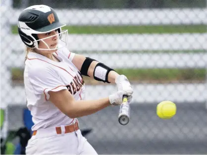  ?? MICHAEL GARD/POST-TRIBUNE PHOTOS ?? Kyla Chevalier, a key part of Wheeler’s first sectional championsh­ip team since 2013, takes a swing during a game against Griffith.
