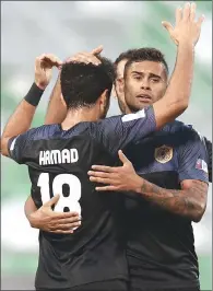  ??  ?? Qatar Sports Club’s Kayke Rodriguez, who scored a hat-trick, celebrates with teammates after scoring one of the goals against Al Gharafa during their Ooredoo Cup match on Saturday.
