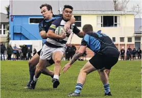  ?? PHOTO: RICHARD DIMMOCK ?? No way through . . . Star winger Hoani Tata’s progress is halted by PiratesOld Boys defenders Sam McLachlan (left) and Josh Buchan during the Southland premier club rugby fixture at Surrey Park in Invercargi­ll.