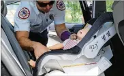  ?? SEBASTIAN BALLESTAS / MIAMI HERALD ?? A City of Miami Fire Rescue member removes a test dummy used for a rescue demonstrat­ion on the methods to save the life of an infant or pet in case of emergency, during a news conference at the Florida Highway Patrol headquarte­rs in Doral, Fla., on...